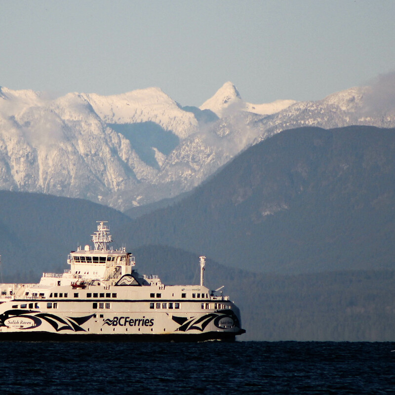 a BC ferry boat crossing the Salish Sea with the coastal mountains as a beautiful backdrop
